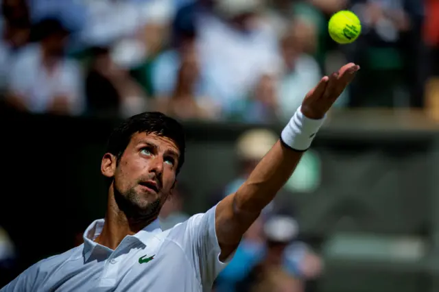 Novak Djokovic serves