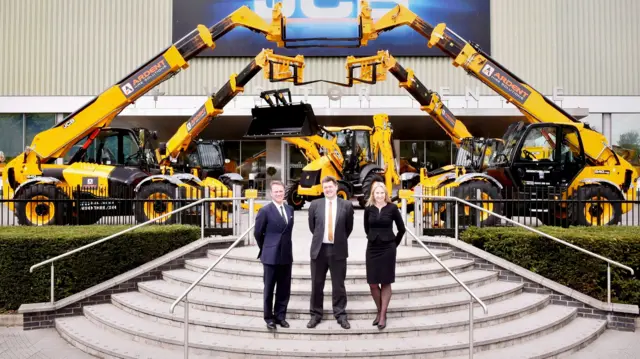 Managers in front of telescopic handlers