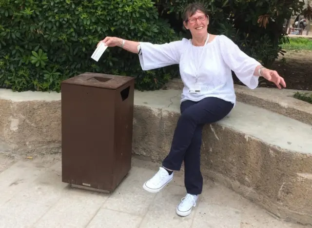 Ruth holding rubbish.