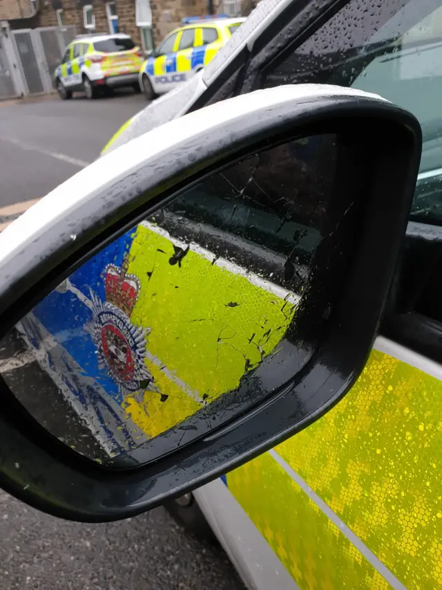 Damaged police car wing mirror