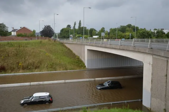 Cars submerged in water on road