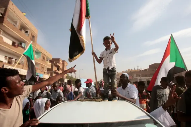 A boy flashes the v fo victory sign as Sudanese protesters demonstrate in Khartoum on July 25, 2019.