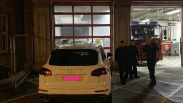 Car in front of fire station