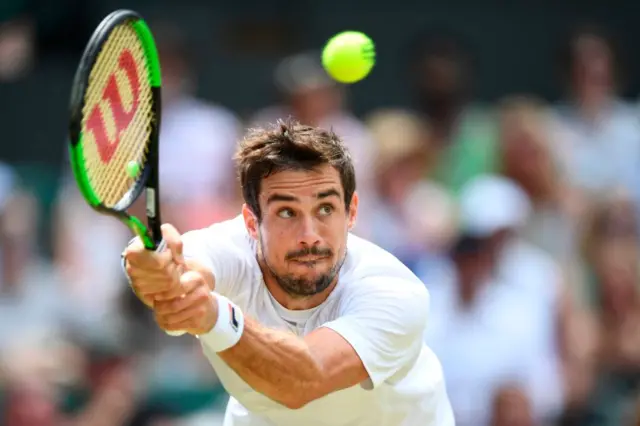 Guido Pella hits a backhand