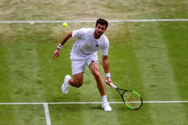 Guido Pella runs for a drop-shot