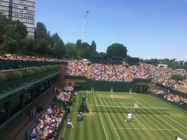 A packed court 18 watches Jamie Murray in the men's doubles