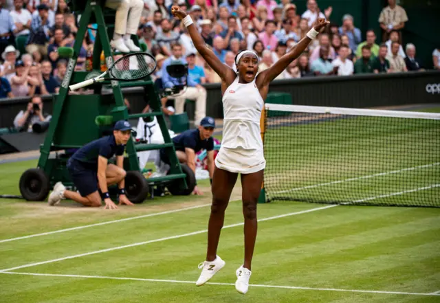 Coco Gauff jumps with her arms in the air in celebration