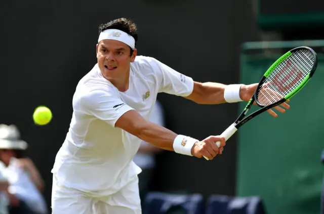 Milos Raonic hits a backhand