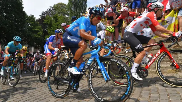 Nairo Quintana heads over the cobbles on stage one