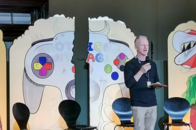 John McGrath speaking on stage at Interdependence 2019