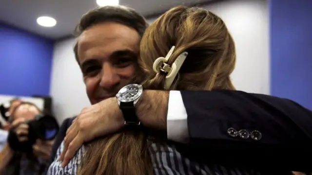 A supporter hugs New Democracy leader Kyriakos Mitsotakis