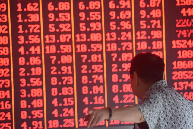 An investor watches the electronic board at a stock exchange hall on June 20, 2019 in Hangzhou, Zhejiang Province of China.