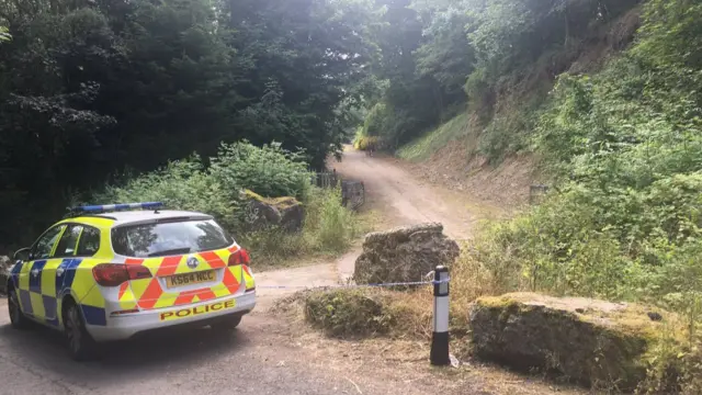 Police car at entrance to quarry