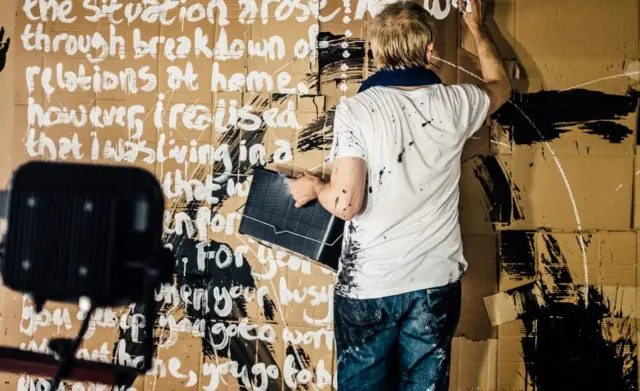 Karl Hyde painting poetry on the walls