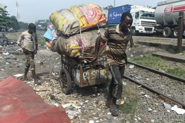 Man pulling a trolley with scrap