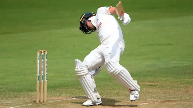 Chris Nash of Nottinghamshire is struck on the helmet by a Jamie Overton bouncer