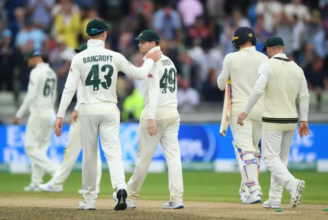 Australia player Steven Smith is congratulated by Cameron Bancroft as the teams leave the field after day one of the First Specsavers Ashes Test Match between England and Australia at Edgbaston