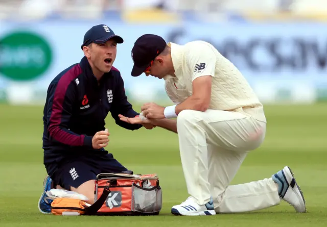 James Anderson (right) receives treatment on his hand