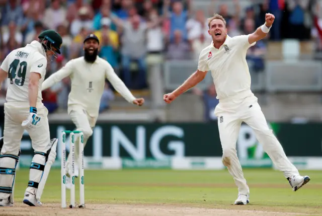 England's Stuart Broad celebrates taking the wicket of Australia"s Steve Smith before he is reinstated following a review