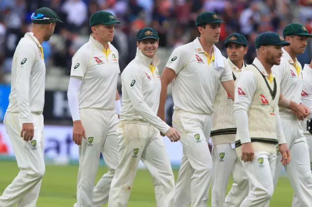 Steve Smith (3L) walks off the field with teammates at close of day's play on the opening day of the first Ashes cricket Test match between England and Australia at Edgbaston in Birmingham
