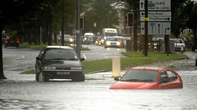 A car is submerged on Boothferry Road in Hull, after heavy rainfall caused flooding.