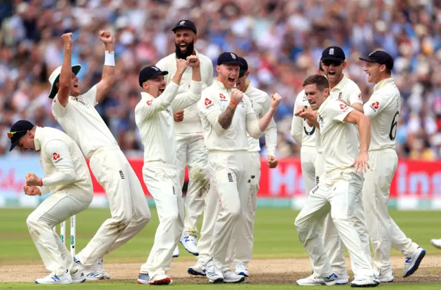 Chris Woakes (right) celebrates taking the wicket of Australia"s Matthew Wade (not pictured) with teammates after review