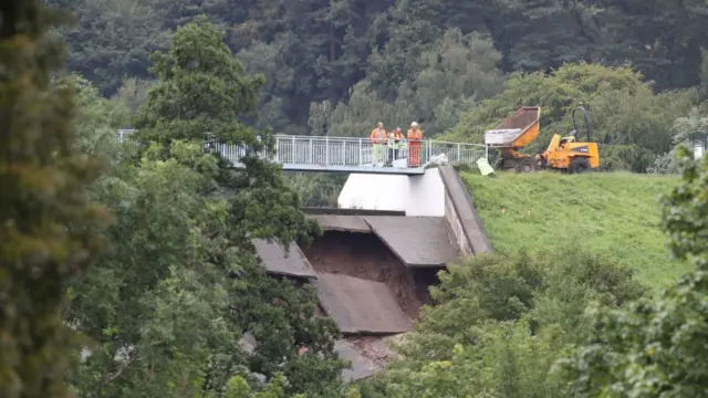 A team look at the damage to Toddbrook Reservoir dam