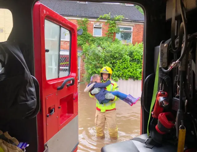 Young boy is rescued from the rising flood waters in Poynton