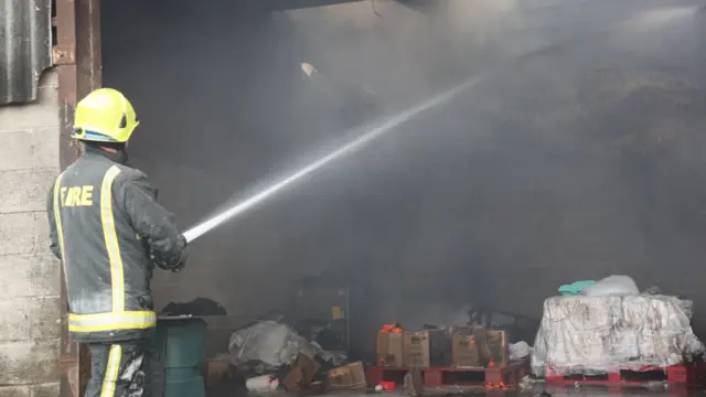 A firefighter with a hose