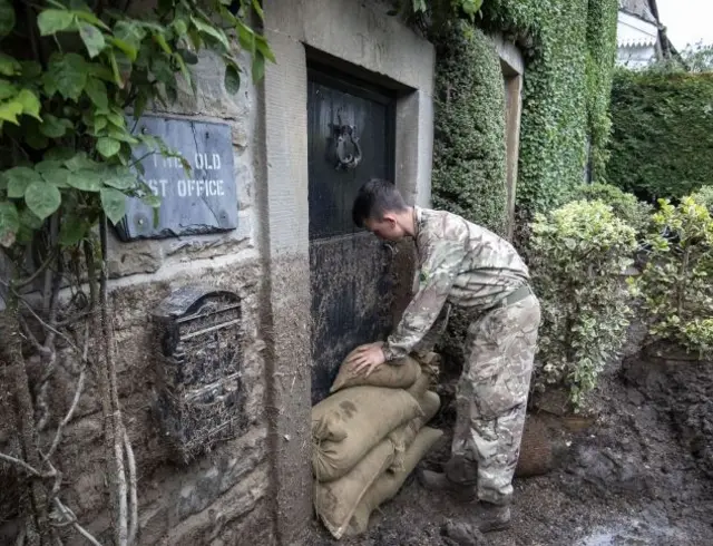 Soldier laying sandbags