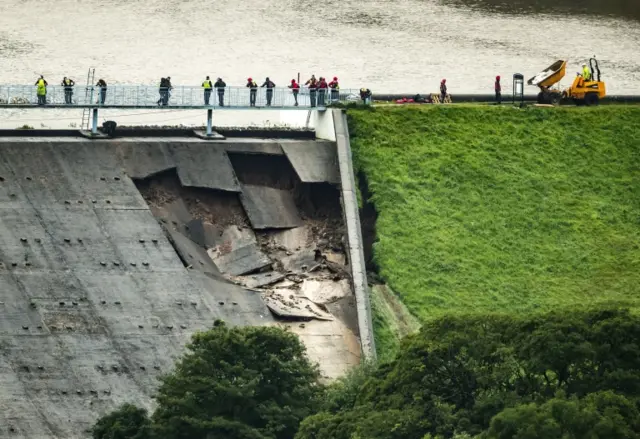 Sandbags are laid at Toddbrook Reservoir after it was damaged in heavy rainfall.