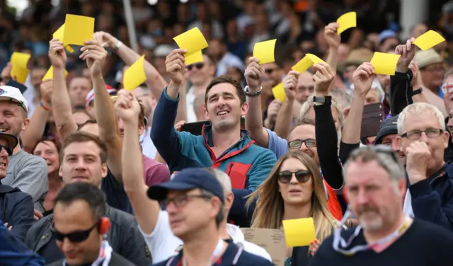 England fans show off their yellow sandpaper during day one of the First Specsavers Ashes Test Match between England and Australia