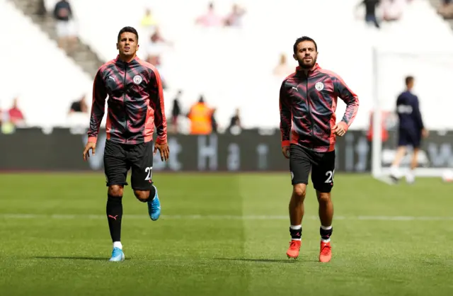 Man City substitutes Bernardo Silva and Joao Cancelo warm up