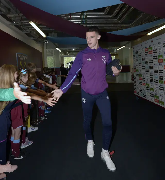 Declan Rice high-fives children on his way into the London Stadium