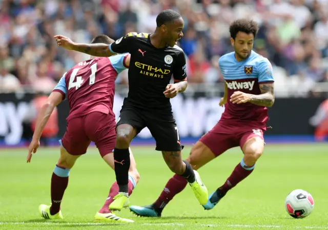 Raheem Sterling is tackled by Declan Rice