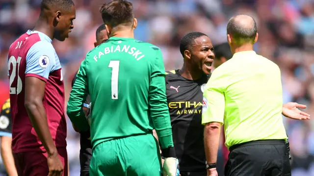 Raheem Sterling remonstrates with referee Mike Dean after he is deemed offside by VAR in the build-up to what would have been Man City's third goal