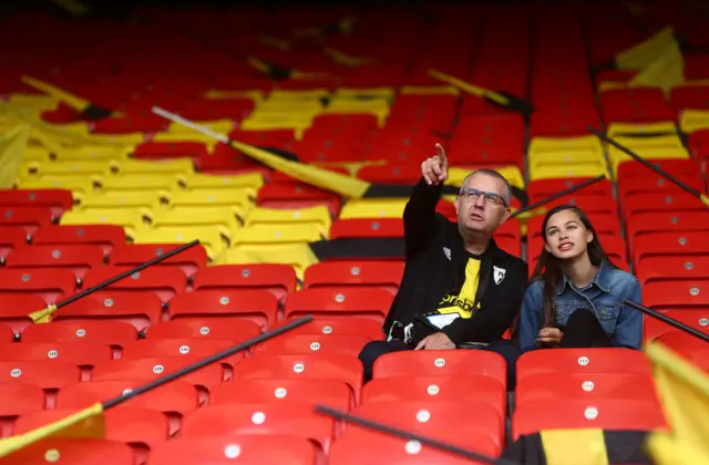 Two Watford fans take their seats