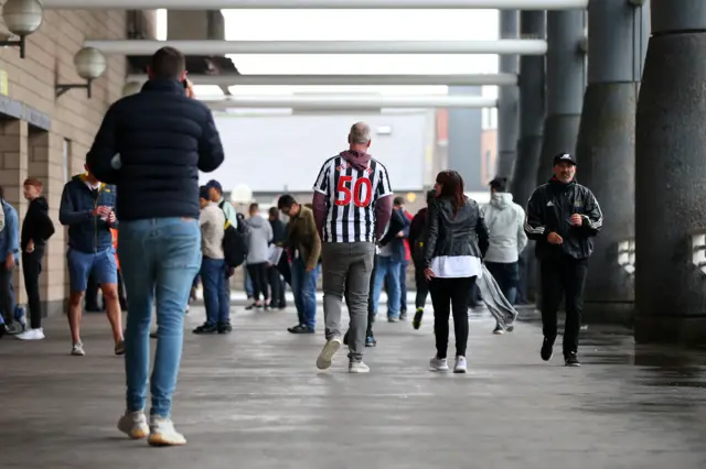 Fans make their way to the stadium