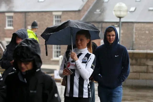 Newcastle fans arrive in the rain to St. James' Park