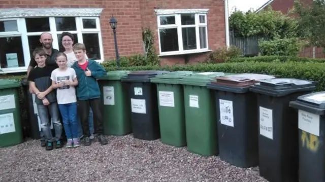 The family by a row of bins