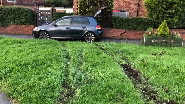 A crashed car into a wall