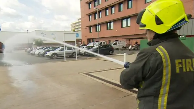 A firefighter with the new hose