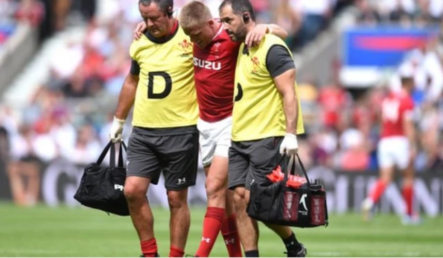 Gareth Anscombe leaves the pitch injured