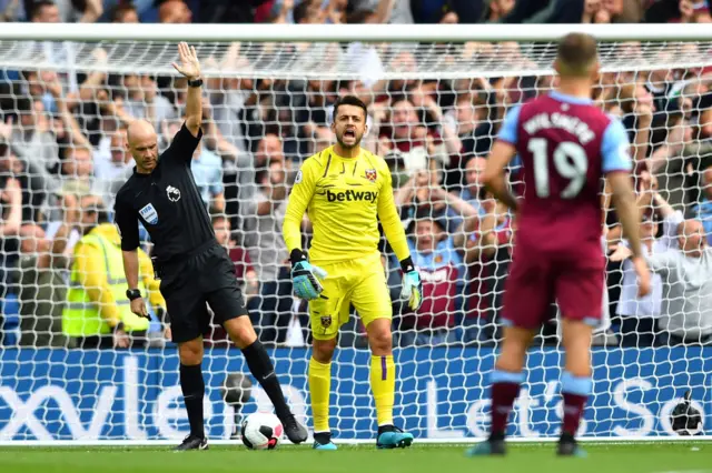 Referee Anthony Taylor consults VAR