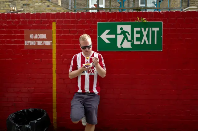 Brentford fan eating a pie