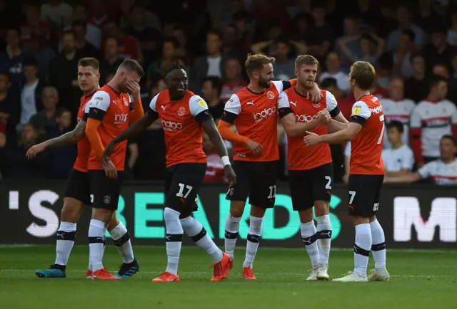 Luton players celebrate a goal