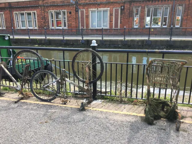 Rusty bikes and shopping trolleys left by the River Witham