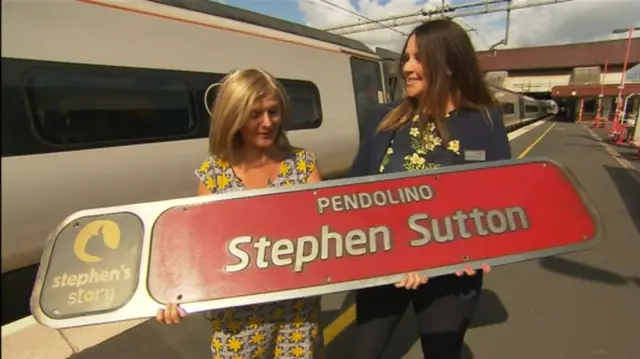 Jane Sutton being presented with sign