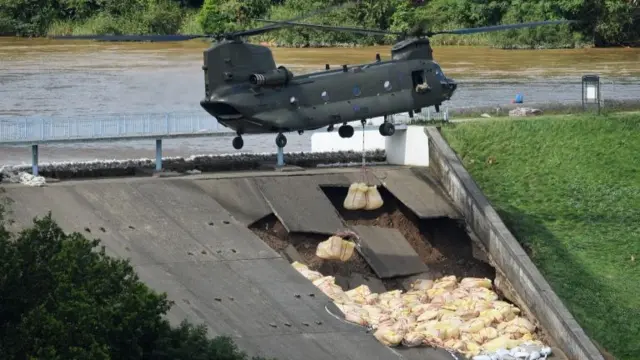 Chinook dropping sand on dam