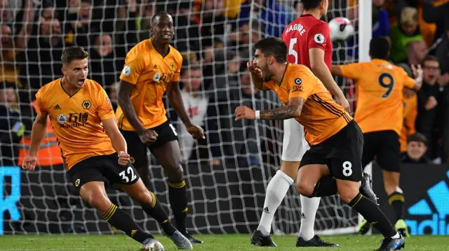 Wolverhampton Wanderers" Portuguese midfielder Ruben Neves (3R) celebrates after scoring the equalising goal